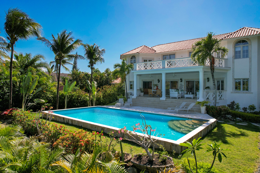 Vista de la piscina y los jardines tropicales de la villa de lujo en Sosúa.